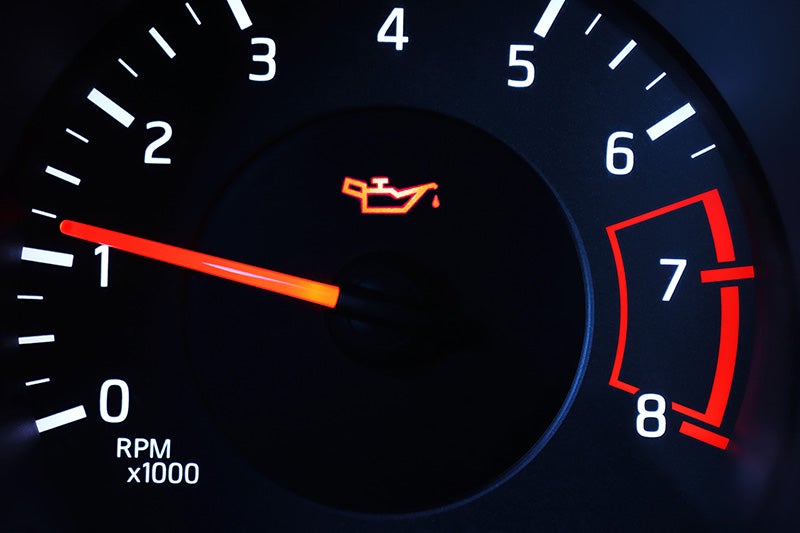 Oil warning indicator illuminated on a vehicle dashboard